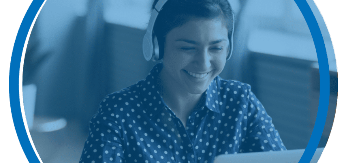 Young Woman with headphones. Smiling at computer