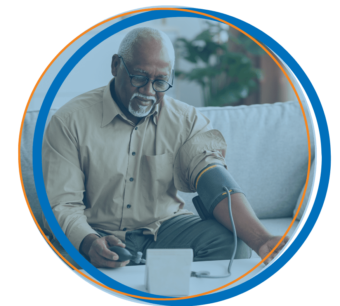 A man with a blood pressure cuff monitoring his vitals from home showing the benefits of remote patient monitoring.